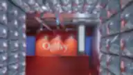 Moderni Ogilvy biuro recepcija – ryškiai raudonas registratūros stalas prie sidabrinių, pūslėtomis struktūromis puoštų sienų