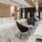 VE 4C3 juodos poilsio kėdės iš BEJOT, modernioje biuro registratūroje su marmuriniu grindų paviršiumi.
